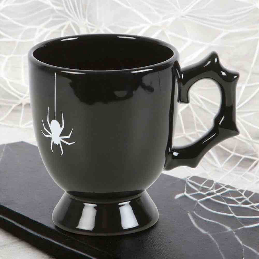 Black gothic-style teacup with spider accent on side and pedestal base