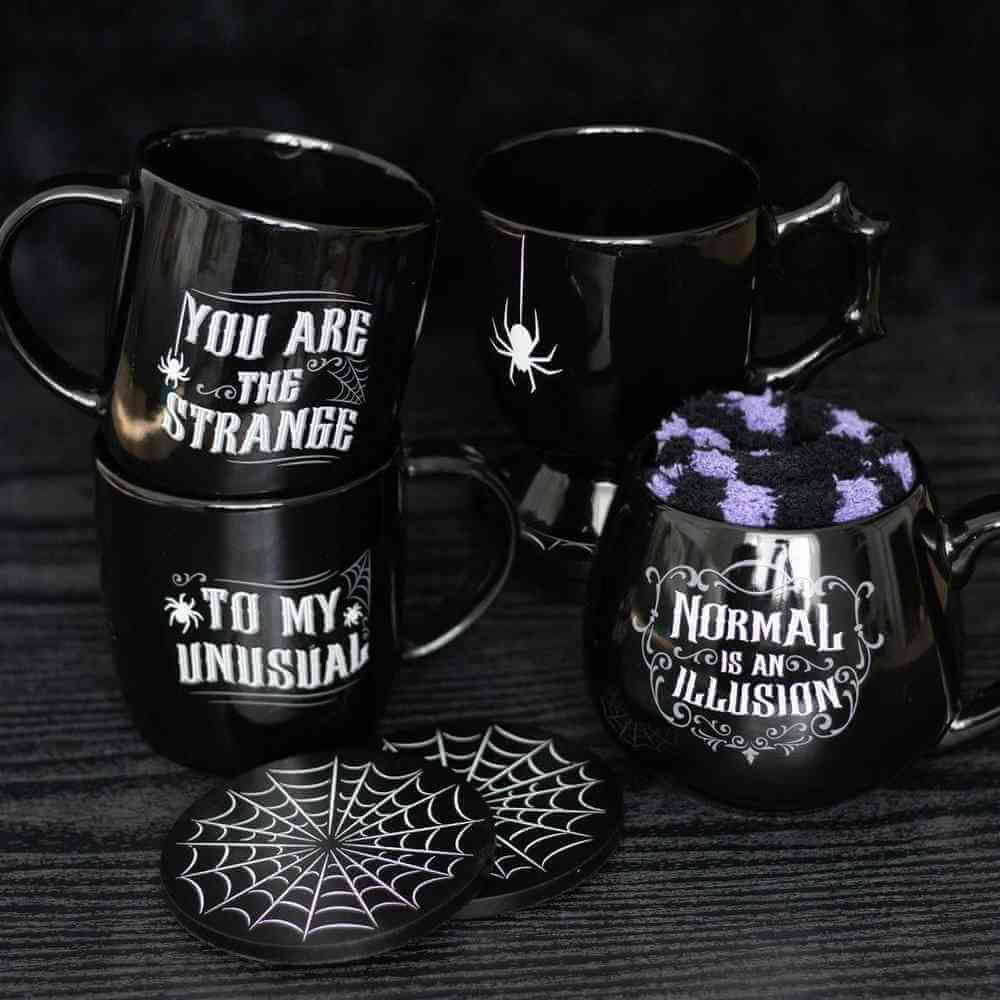 Set of black gothic teacups with spider web motifs and printed Halloween text