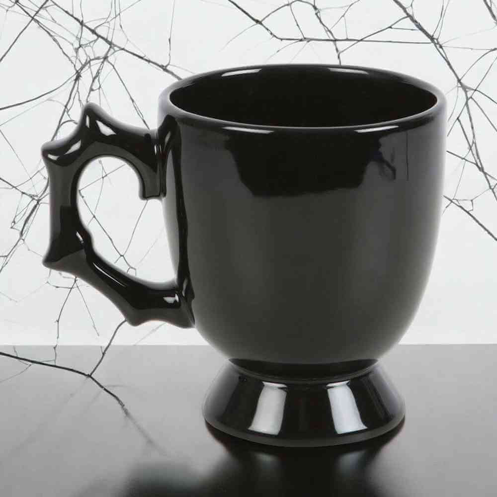 Black gothic-style teacup with spiked batwing handle and glossy finish