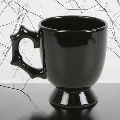 Black gothic-style teacup with spiked batwing handle and glossy finish