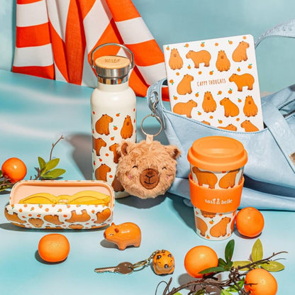 Capybara travel coffee mug, white with orange lid and 'Sass & belle' band, metal top