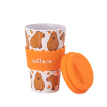 Capybara travel coffee mug with orange lid, cap off, capybara pattern on white body