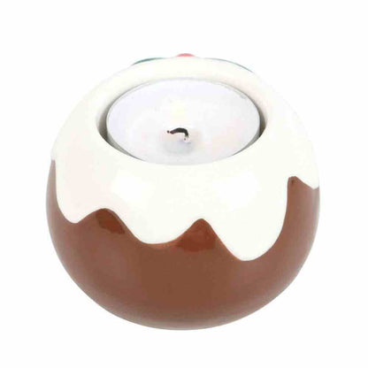 Pudding-shaped tealight candle holder with white drip top and brown base, lit tealight inside