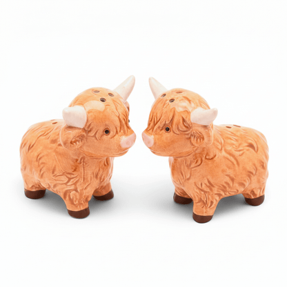 Highland cow salt and pepper shakers facing each other, orange-brown ceramic