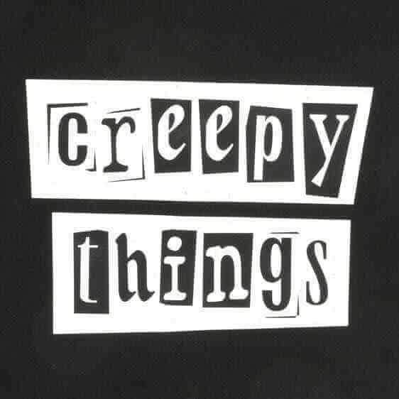 Close-up of 'Creepy Things' logo print on a black polycotton tote bag