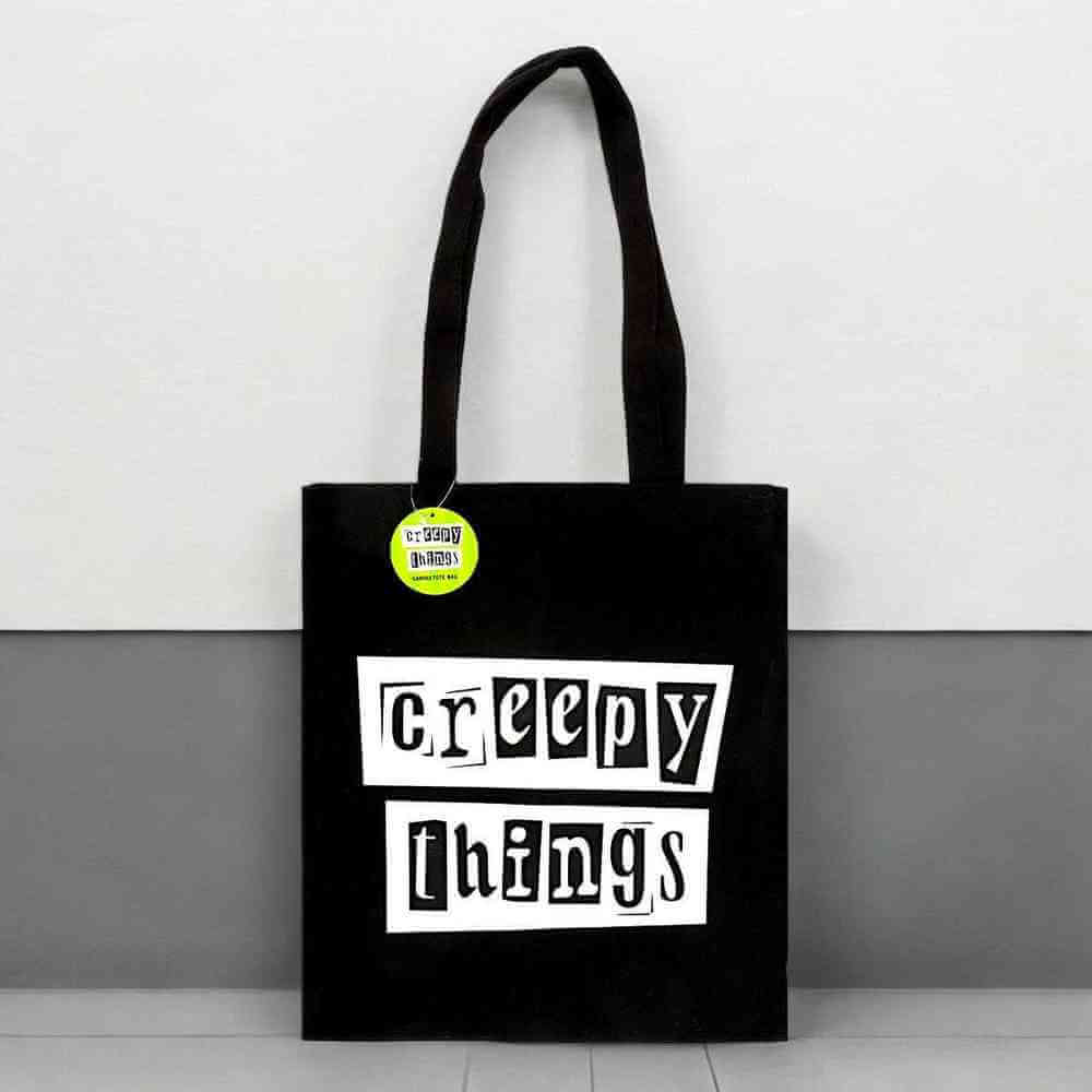Black polycotton tote bag with 'Creepy Things' front text in white boxes