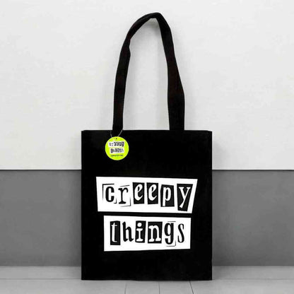 Black polycotton tote bag with 'Creepy Things' front text in white boxes