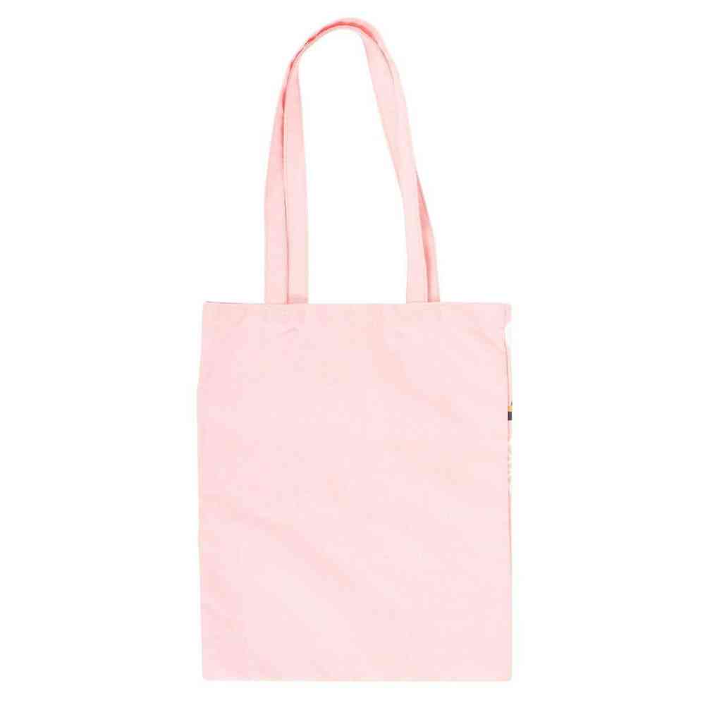 Pink solid tote bag with top handles and small side label