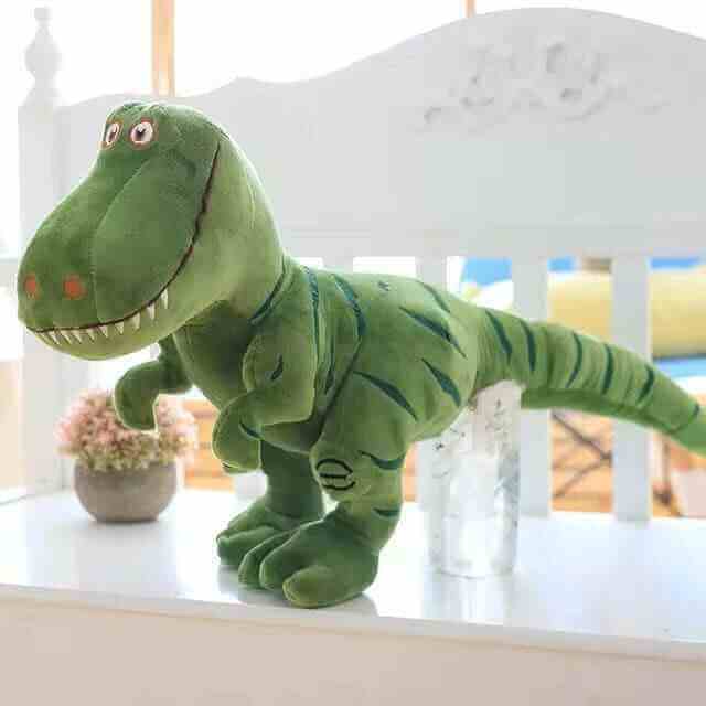 Green dinosaur plush toy T-rex with open mouth and embroidered eyes, lying down