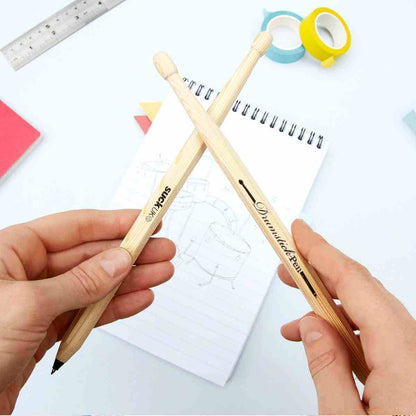 Drumstick pens set of 2, hands holding two light wood pens with black ink tips