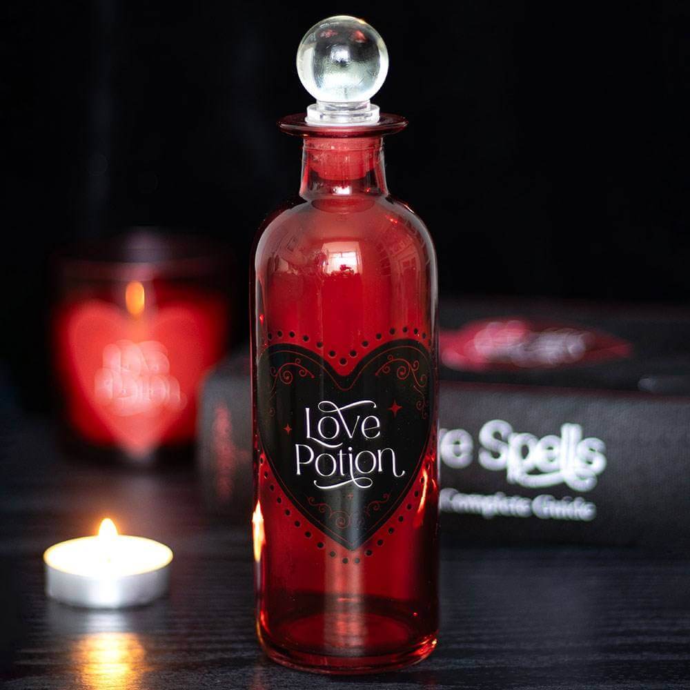Red glass love potion bottle with crystal-like stopper and heart label