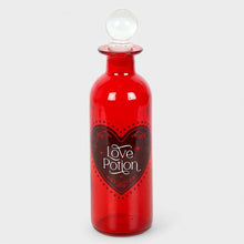 Red glass love potion bottle with clear crown stopper and heart label