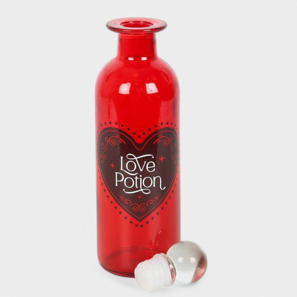 Red glass love potion bottle with heart label and white stopper