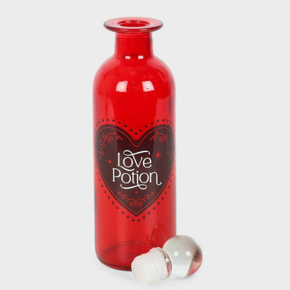 Red glass love potion bottle with heart label and white stopper