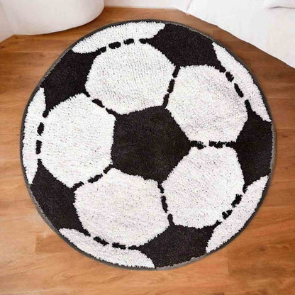 Round football-shaped rug with white soccer balls on a dark background, dashed outlines.