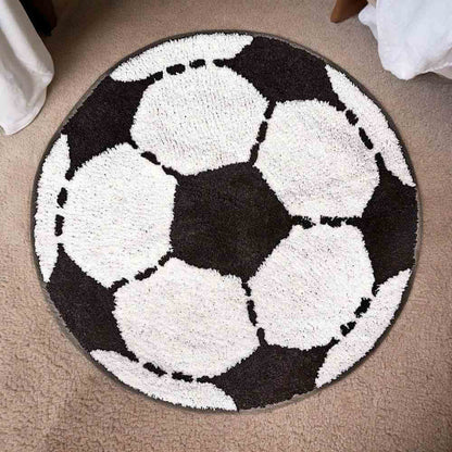 Round football-shaped rug featuring white soccer balls on a dark background with dashed seams.