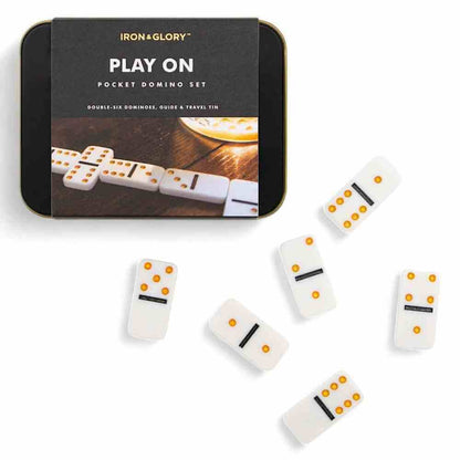 Iron&Glory Play On pocket domino set with white domino tiles scattered on a flat surface