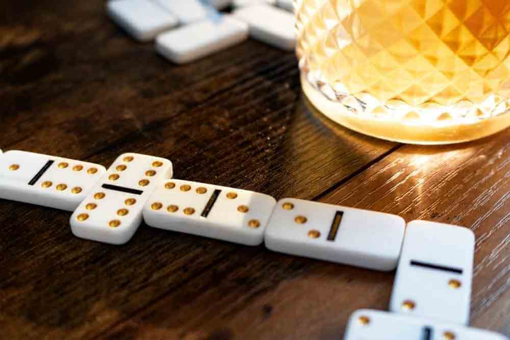 White domino tiles with orange dots and dark lines, arranged in a chain