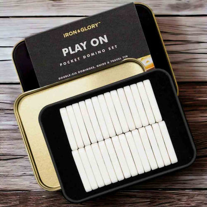 Iron&Glory pocket domino set with open tin and white domino tiles in a black tray