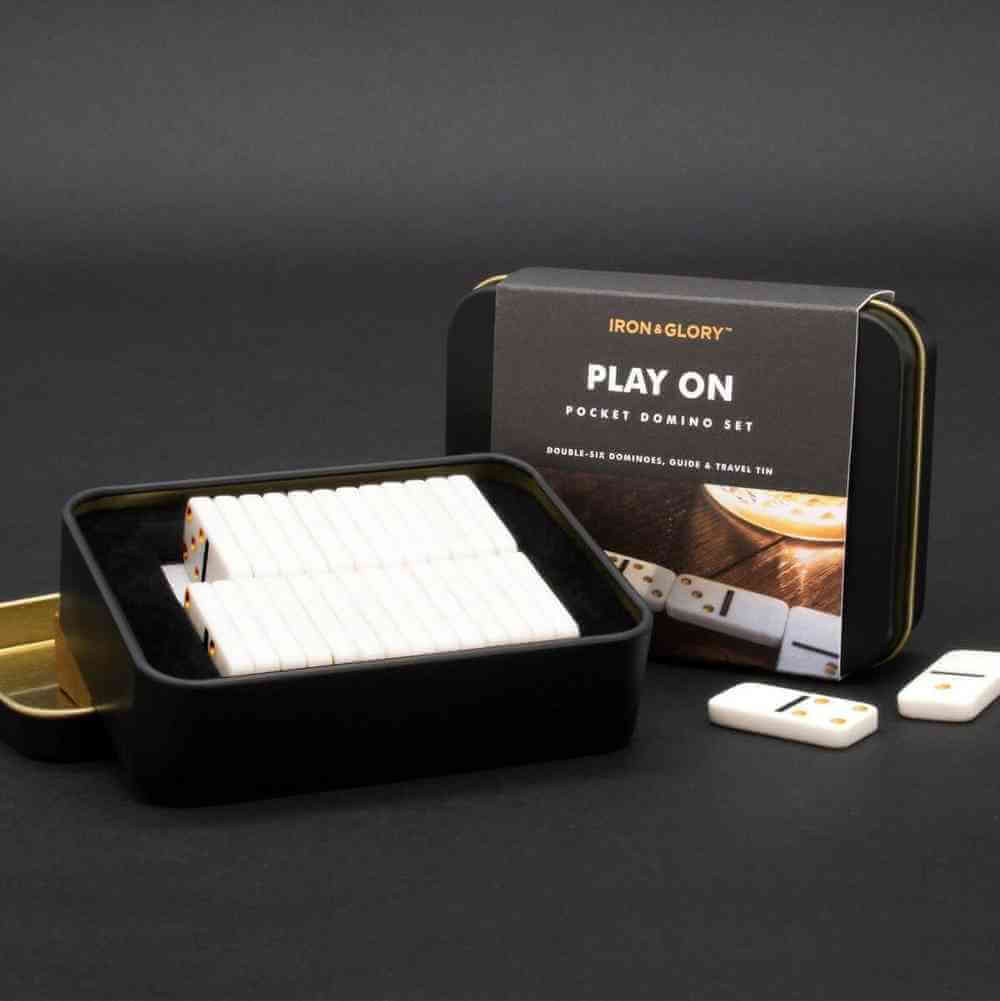 Mini travel domino set in a black pocket tin, with white domino tiles inside