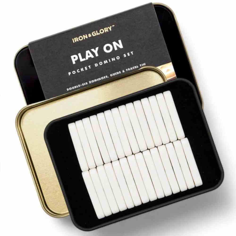Iron&Glory pocket domino set with open tin and white domino tiles in a black tray