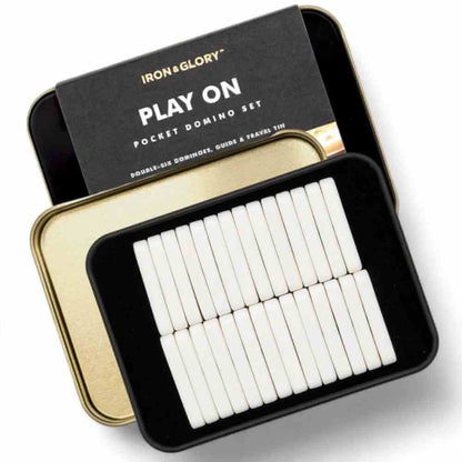 Iron&Glory pocket domino set with open tin and white domino tiles in a black tray