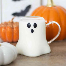 Ghost-shaped clear glass mug with smiling black face and curved handle