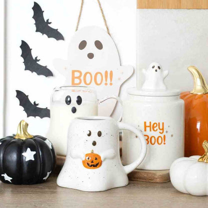 Ghost-shaped clear glass mug with black face and curved handle