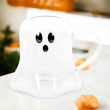 Ghost-shaped clear glass mug with black eyes and mouth, curved handle
