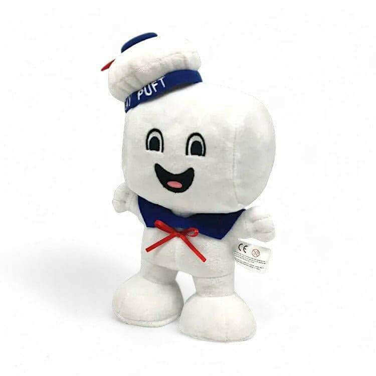 White plush Stay Puft character standing, blue collar and red bow, friendly smile