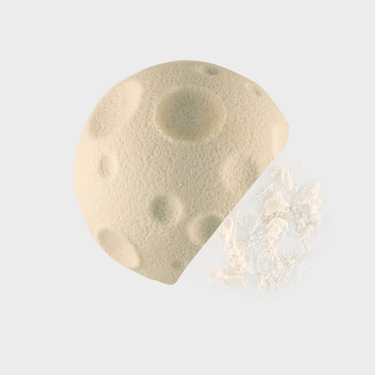 Moon-shaped rubber eraser beside a broken crumpled eraser piece