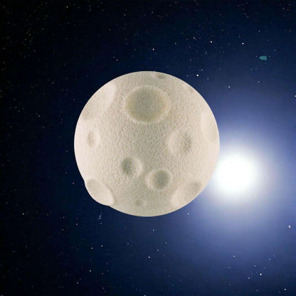 Cream moon-shaped rubber eraser with raised crater-like embossed details