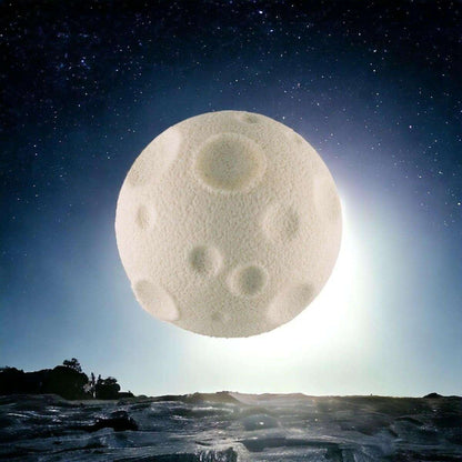 Cream moon-shaped rubber eraser, round with crater dimples on the surface