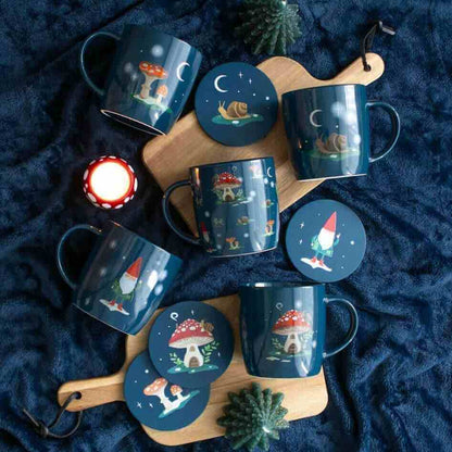 Round navy coaster with gnome scenes; includes mugs and an extra coaster on board