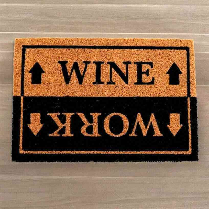 Humorous entryway doormat with orange top panel reading WINE and black panel reading WORK