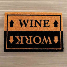 Humorous entryway doormat with orange top panel reading WINE and black panel reading WORK