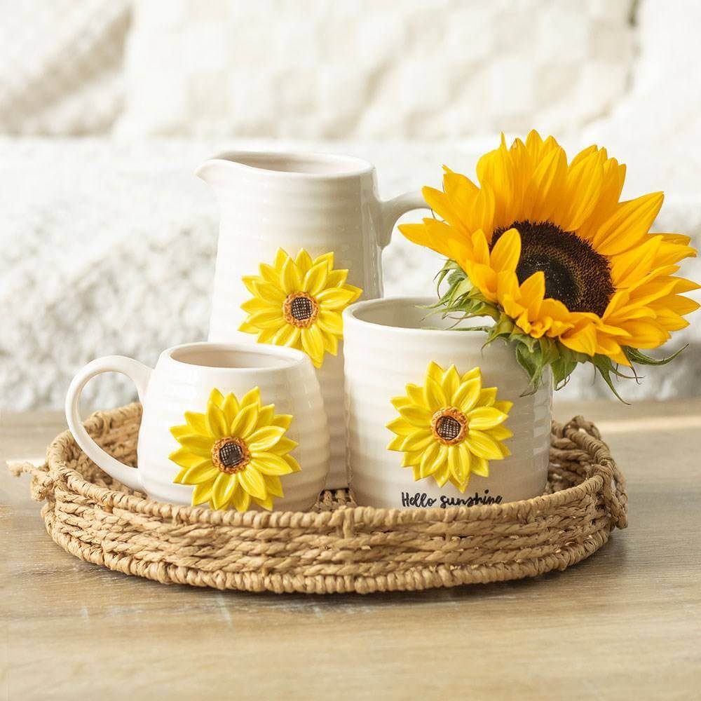 Set of small ceramic plant pots with sunflower accents in a woven tray