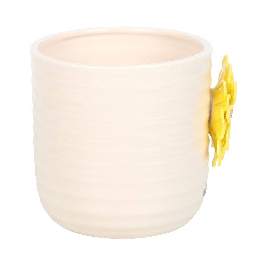 Cream ceramic plant pot with small 3D sunflower on the side