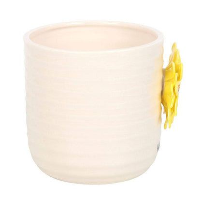 Cream ceramic plant pot with small 3D sunflower on the side