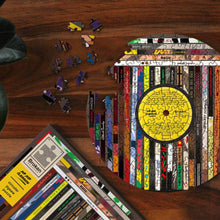Circular vinyl-themed jigsaw puzzle with yellow record label and scattered puzzle pieces