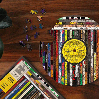 Circular vinyl-themed jigsaw puzzle with yellow record label and scattered puzzle pieces