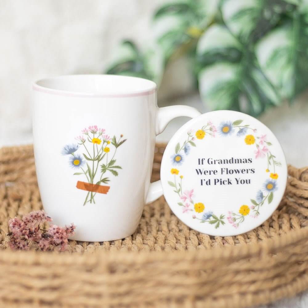 White ceramic mug with wildflower design and matching round floral coaster