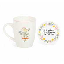 White ceramic mug and round coaster with wildflower wreath and quote text