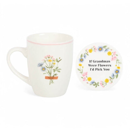 White ceramic mug and round coaster with wildflower wreath and quote text