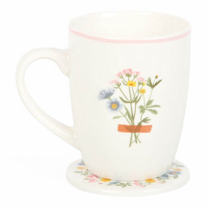 White ceramic mug with wildflower bouquet design and floral coaster underneath
