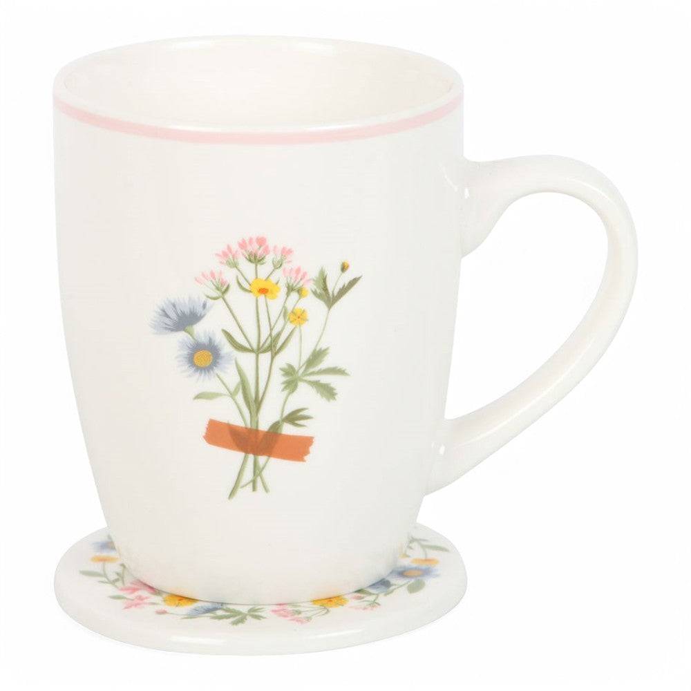 White ceramic mug with bouquet in orange pot and pink rim, shown with matching floral coaster