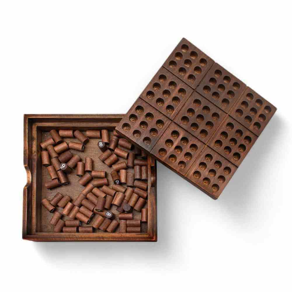 Wooden Sudoku board with spare pegs in open tray and grid insert