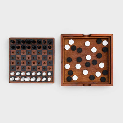 Wooden chess and checkers boards side by side with dark and light pieces in play