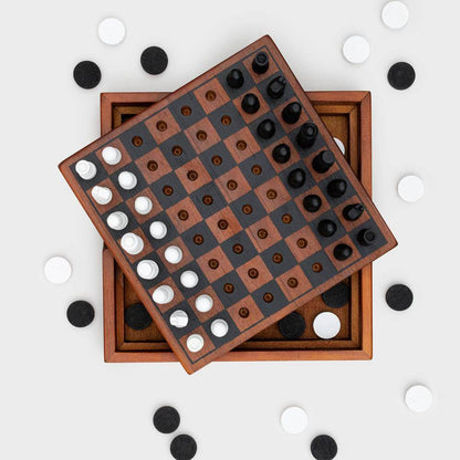 Wooden chess and checkers boards with dark and white round pieces scattered around