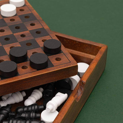 Wooden chess and checkers set open with compartment holding white and black game pieces